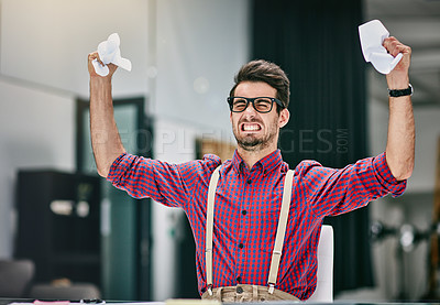 Buy stock photo Cropped shot of a frustrated young designer crumpling paper while sitting in his office