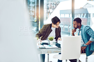 Buy stock photo Cropped shot of two young businessmen working together in the office