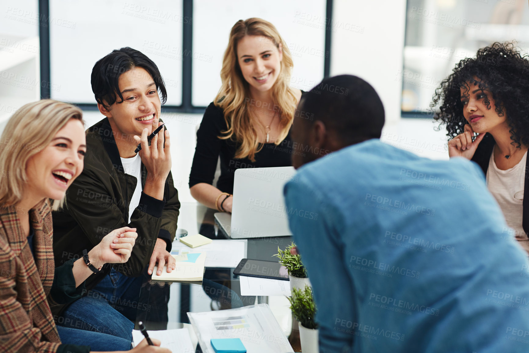 Buy stock photo Talking, planning or meeting group of colleagues brainstorming ideas, discussing strategy on technology and paperwork. Laughing, smiling and happy diverse creative marketing team in office boardroom