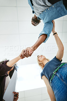 Buy stock photo Business people, handshake and meeting below with team in partnership, greeting or collaboration at office. Low angle of creative employees shaking hands for startup agreement, b2b deal or hiring