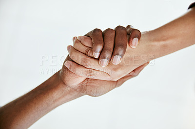 Buy stock photo Cropped shot of two people shaking hands