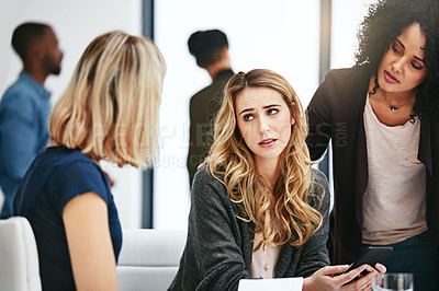 Buy stock photo Shot of a sad young woman being comforted by her colleagues during a meeting at work