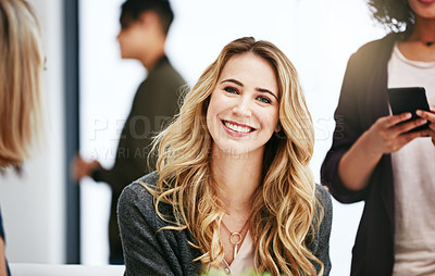 Buy stock photo Beautiful, stunning and attractive female fashion designer smiling in a busy workshop or studio. Portrait of a young caucasian fashion creative with a bright smile sitting inside an office