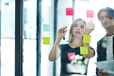 Buy stock photo Businesspeople in brainstorm, thinking and planning session in a modern office. Creative team sharing ideas and strategy for collaboration at the workplace. Business people at work with sticky notes.