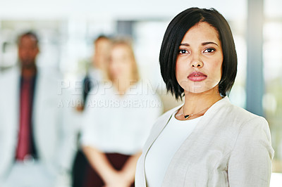 Buy stock photo Serious, focused and confident female lawyer looking at the camera and standing in her office with her team. Portrait of a leader, smart and intelligent attorney that is tough and resilient