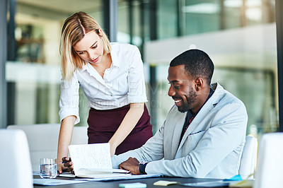 Buy stock photo An HR manager training new employee, intern or business man in a modern office. Young colleagues working, planning and brainstorming together and helping each other with a project in the workplace