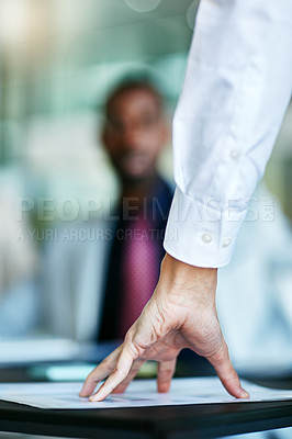 Buy stock photo Angry, annoyed and frustrated HR manager having a meeting or interview with employee. Closeup of a hand on paperwork during a dismissal. Worker being fired or dismissed by employer losing his temper