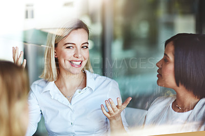 Buy stock photo Female office worker on a break with colleagues talking and having a conversation at work. Business people spending time together inside. Smiling corporate business woman with team indoors