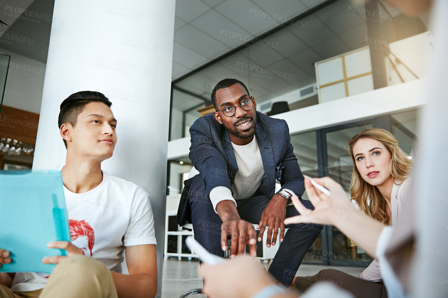 Buy stock photo Shot of a group of colleagues having a brainstorming session in a modern office