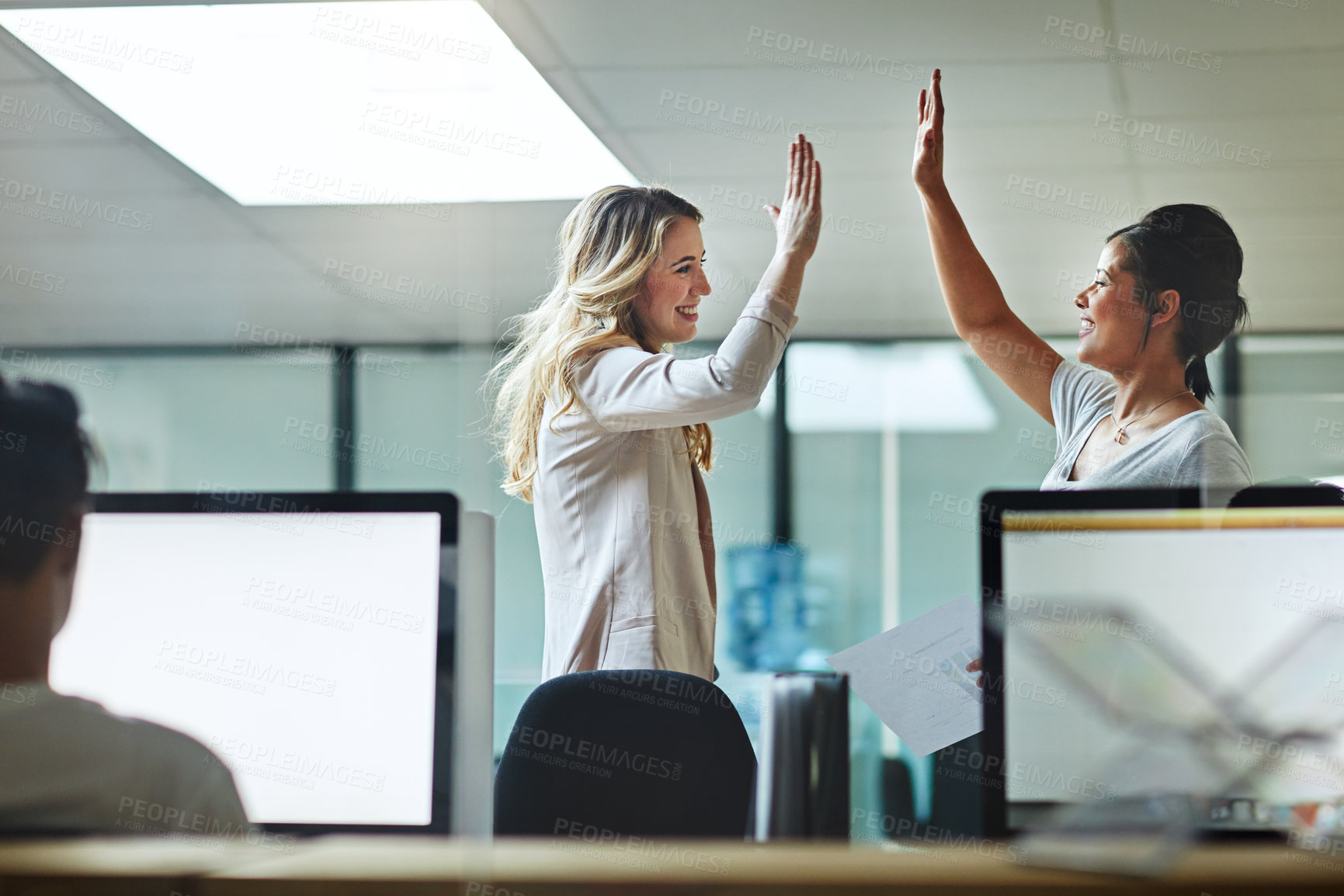 Buy stock photo High five, teamwork and winning are important to a successful professional collaboration at work together. Happy and excited businesswoman celebrates a job promotion with a coworker at the office
