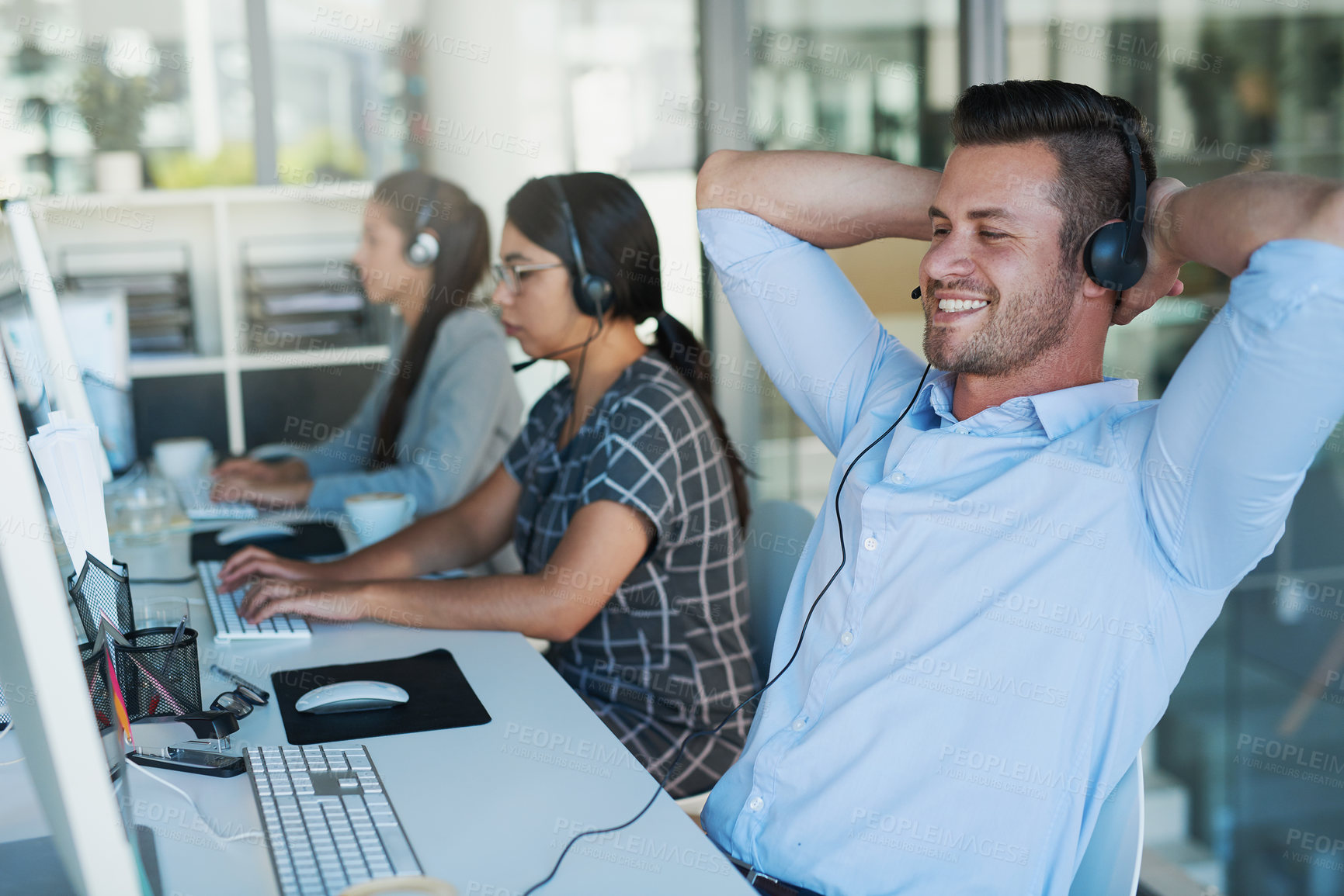 Buy stock photo Call center, break and man at computer with customer service and crm work. Conversation, smile and phone consultant relax at a coworking office with headset and operator with web advice at desk