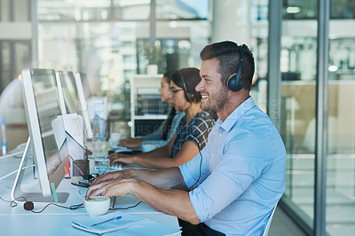 Buy stock photo Shot of a team of call center agents working in an office