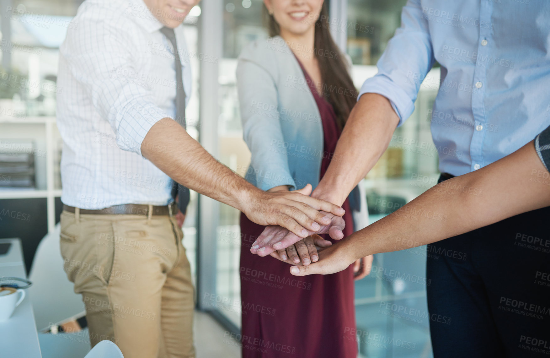 Buy stock photo Shot of a group of colleagues joining their hands together in solidarity