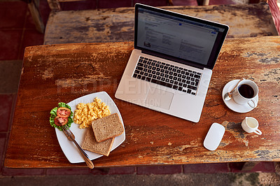 Buy stock photo High angle shot of a laptop and freshly made breakfast on a table