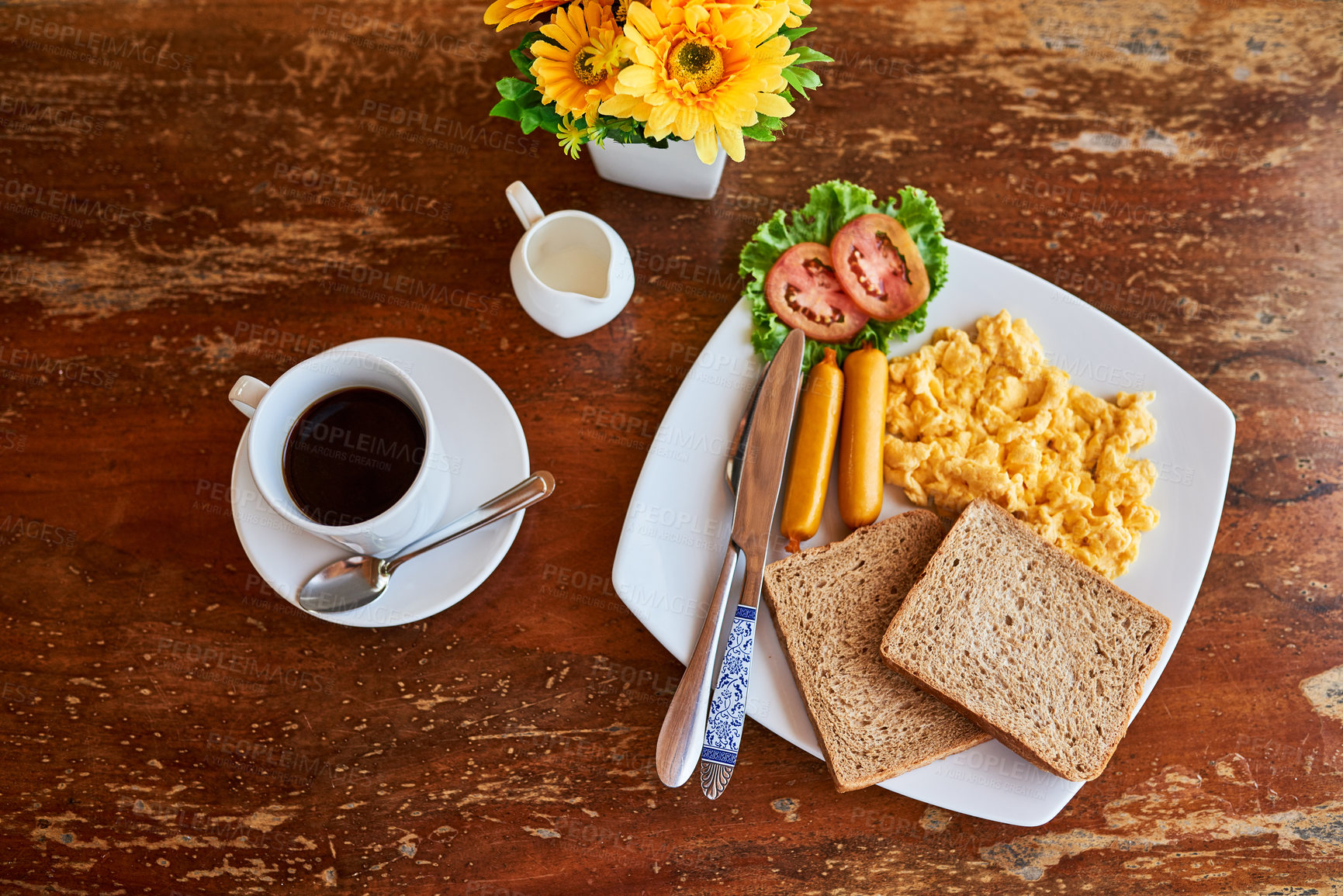 Buy stock photo High angle shot of a cup of coffee and freshly made breakfast on a table