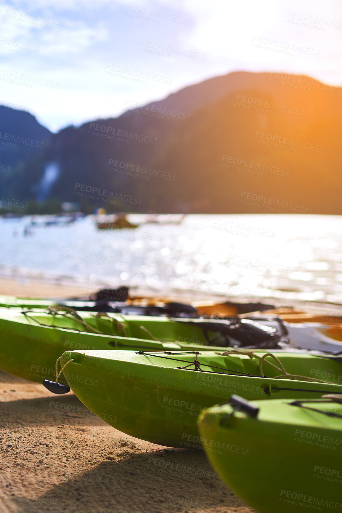 Buy stock photo Shot of three canoes on the shore of a tropical beach