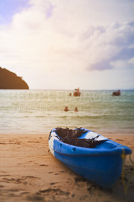Buy stock photo Shot of a single canoe on the shore of a tropical beach