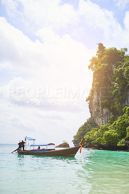 Buy stock photo Shot of a man standing on a boat floating in tropical waters