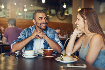 Buy stock photo Cropped shot of a young couple on a date in a cafe