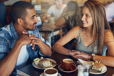 Buy stock photo Cropped shot of a young couple on a date in a cafe