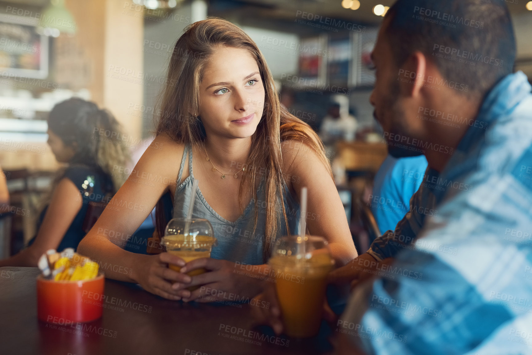 Buy stock photo Cropped shot of a young couple on a date in a cafe