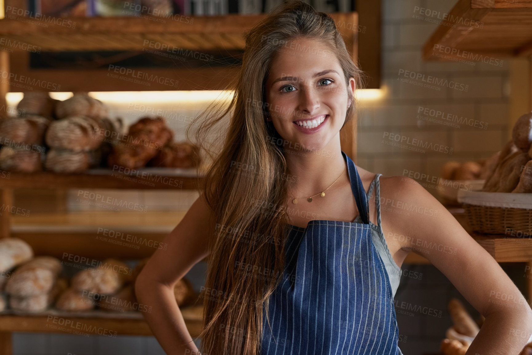 Buy stock photo Portrait of a young business owner standing in her bakery