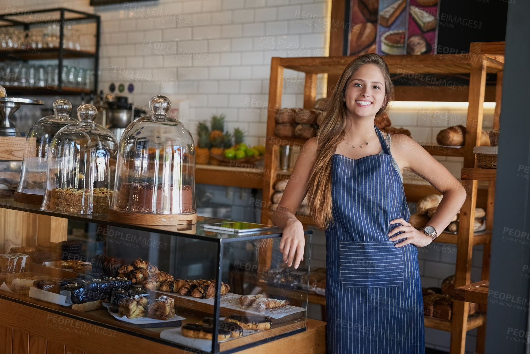 Buy stock photo Portrait of a young business owner standing in her bakery