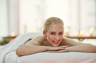 Buy stock photo Portrait of a young woman relaxing on a massage table at a spa