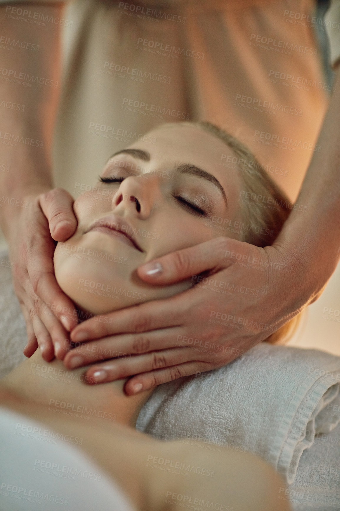 Buy stock photo Hands, woman and head on massage table at spa for health, wellness and relax for hospitality at resort. Masseuse, people and care on bed, treatment and physical therapy for healing at luxury salon