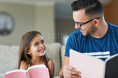 Buy stock photo Father, girl and books for reading in home, literature and language for child development on couch. daddy, daughter and fiction or fantasy novel for knowledge, story and bonding together for learning