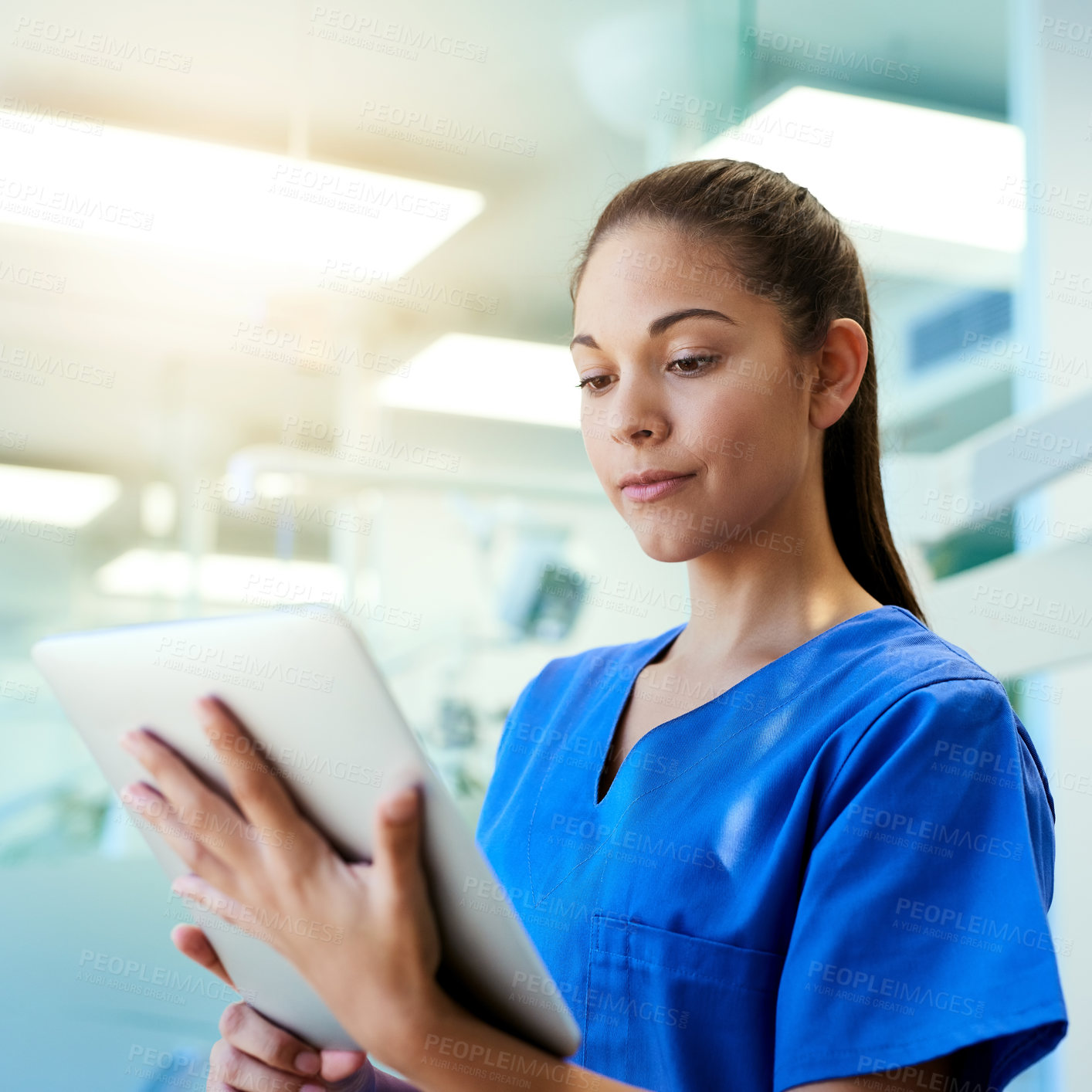 Buy stock photo Woman, nurse and reading on tablet in hospital for medical research, telehealth and digital consultation. Medicine, professional and tech app in clinic for patient data, medicare schedule and results