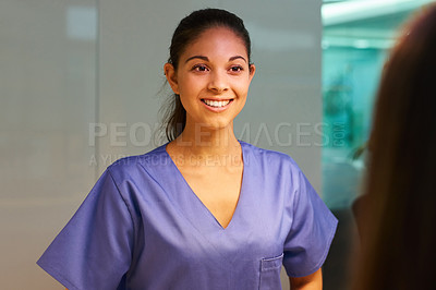 Buy stock photo Rearview shot of a young nurse greeting a patient in the clinic