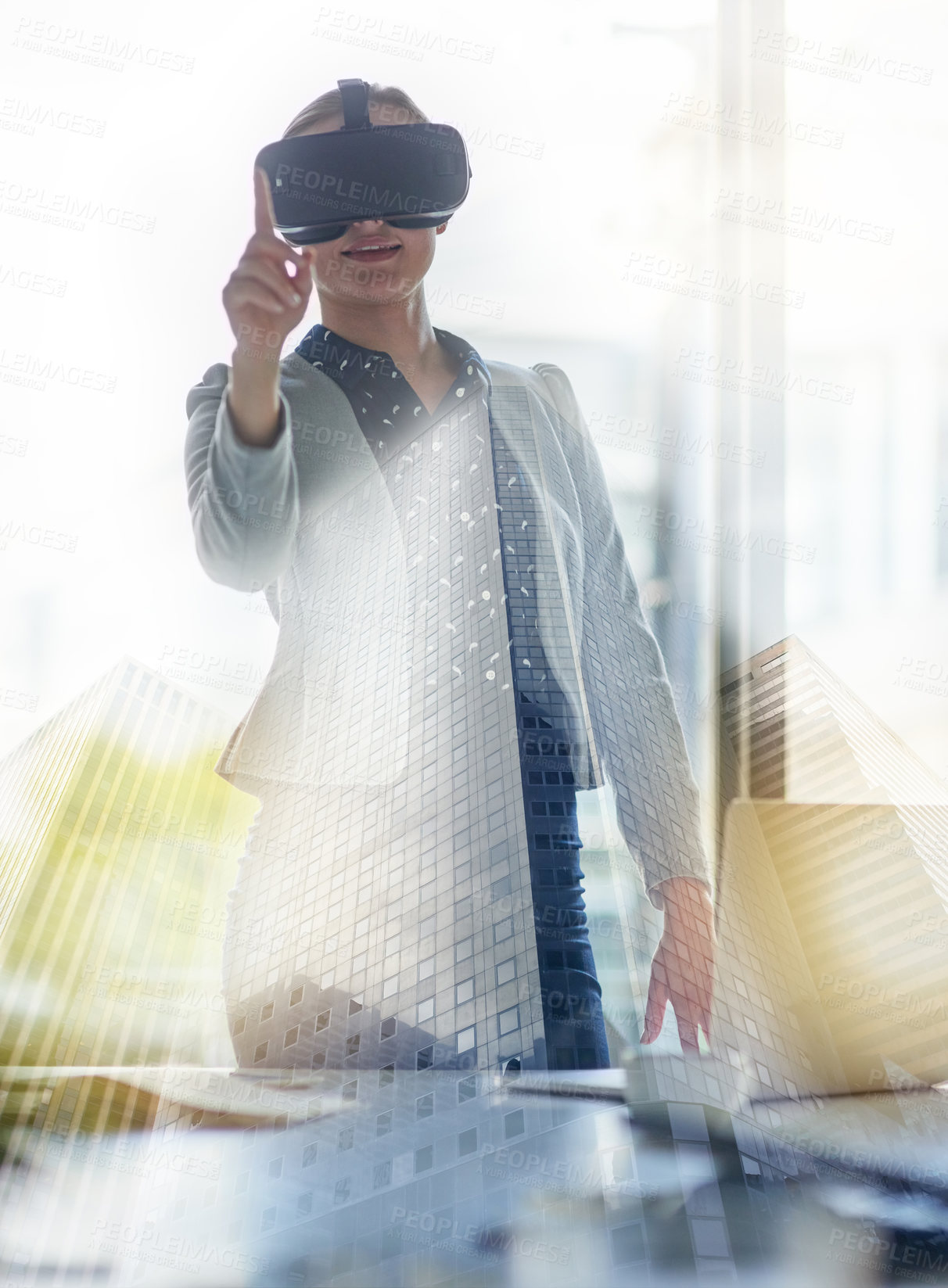 Buy stock photo Shot of a young businesswoman wearing a virtual reality headset at work