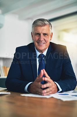 Buy stock photo Portrait of a confident businessman posing behind his desk
