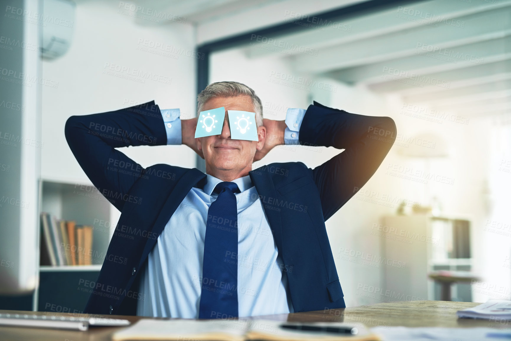 Buy stock photo Shot of a businessman relaxing behind his desk with adhesive notes over his eyes