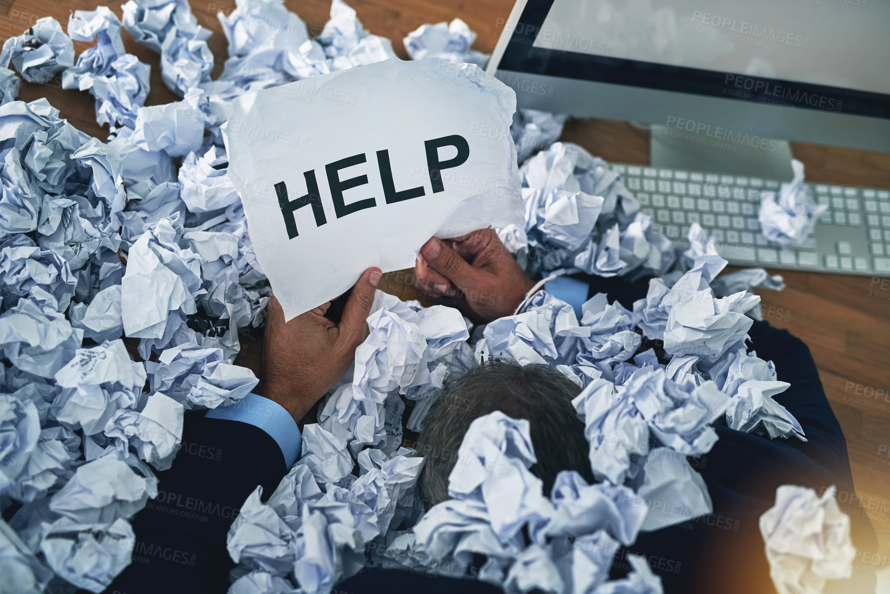 Buy stock photo Shot of an unidentifiable businessman asking for help while drowning under a pile of paperwork