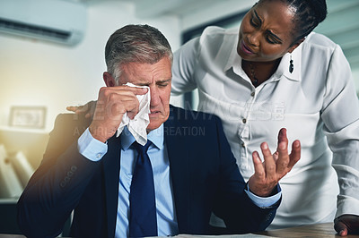 Buy stock photo Shot of a concerned businesswoman consoling her crying colleague at his desk