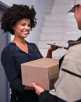 Buy stock photo Shot of a happy businesswoman accepting a package from a courier in the office