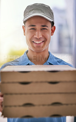 Buy stock photo Portrait of a happy deliveryman holding a stack of pizza boxes