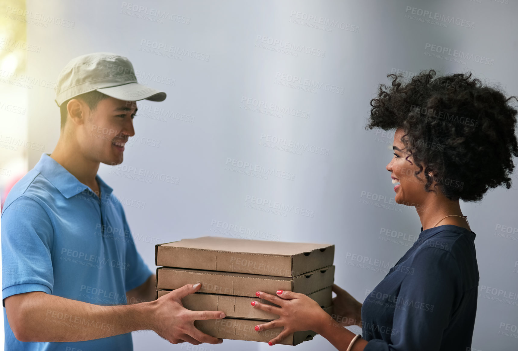 Buy stock photo Shot of a happy businesswoman accepting a pizza delivery from a delivery man in the office