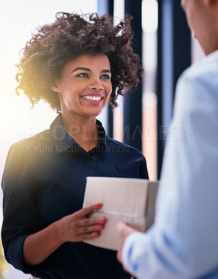 Buy stock photo Shot of a happy businesswoman accepting a package from an unidentifiable courier in the office