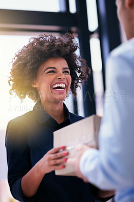 Buy stock photo Shot of a happy businesswoman accepting a package from an unidentifiable courier in the office