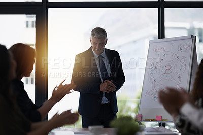 Buy stock photo Shot of a team of silhouetted businesspeople attending a meeting in the boardroom