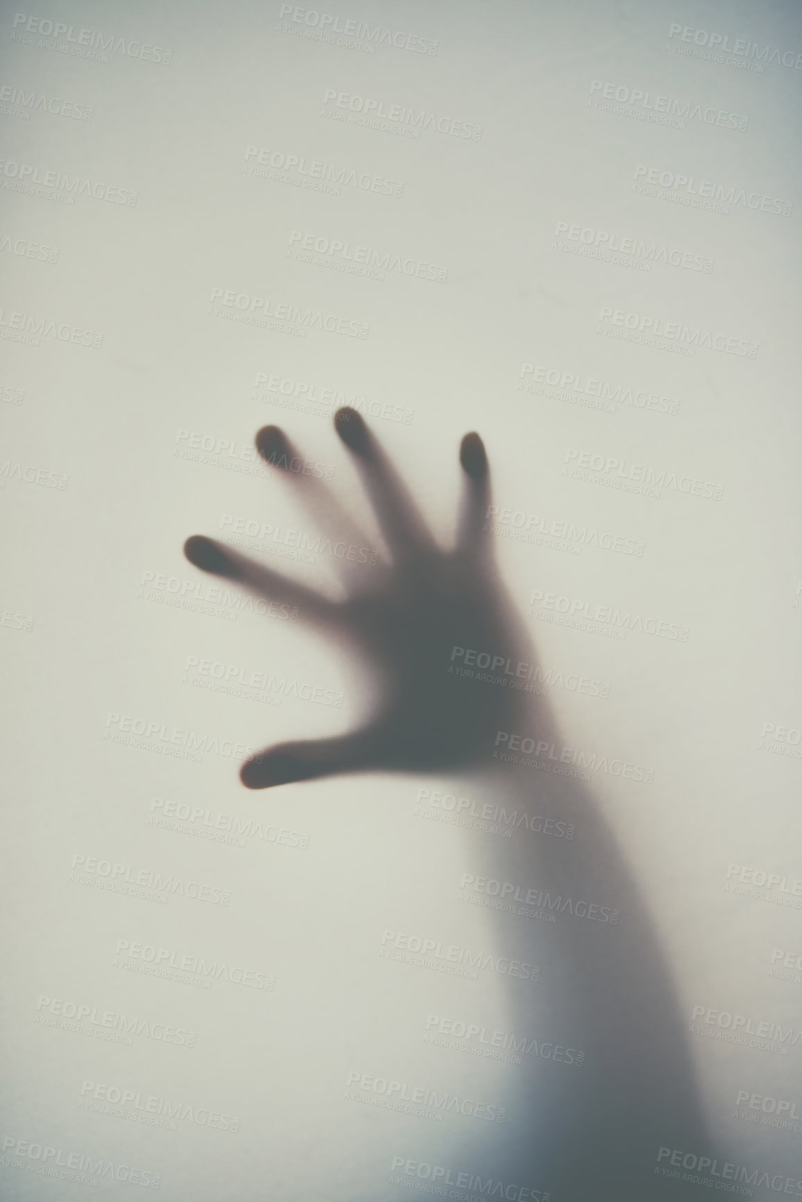 Buy stock photo Defocussed shot of a single hand reaching out against a plain background