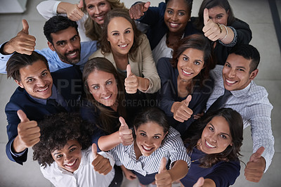 Buy stock photo High angle portrait of a group of coworkers showing a thumbs up in the office