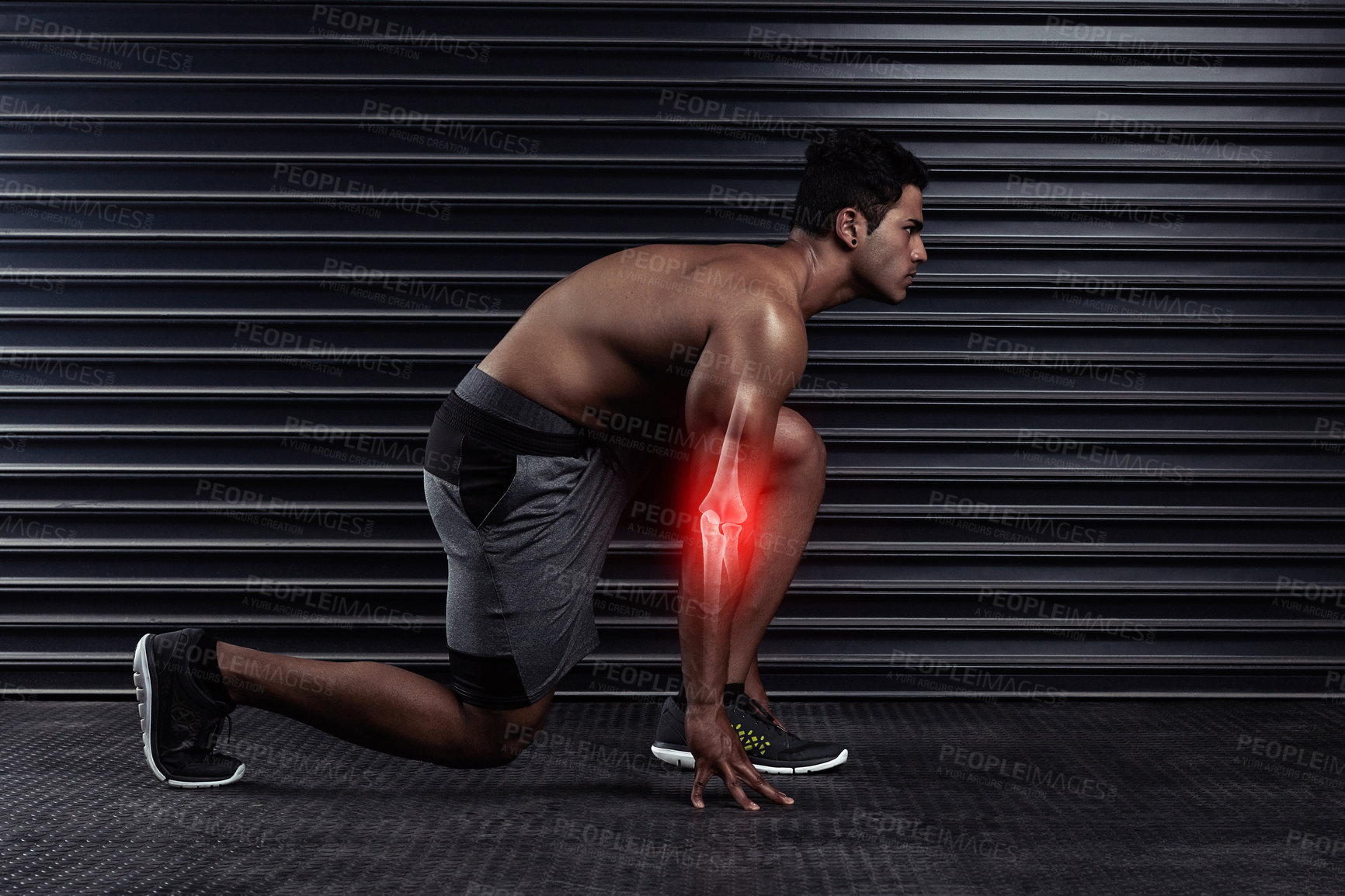 Buy stock photo Full length shot of an athletic young man on his mark before a run