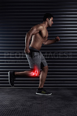 Buy stock photo Full length shot of a handsome young man running against a dark background