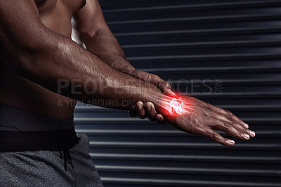 Buy stock photo Shot of an unrecognizable man rubbing his injured hand during a workout