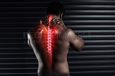 Buy stock photo Rearview shot of an athletic young man holding his back in pain during a workout