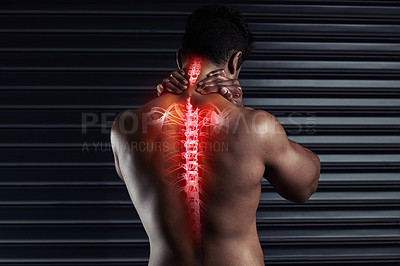 Buy stock photo Rearview shot of an athletic young man holding his back in pain during a workout